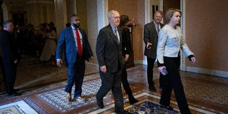 US Senate Minority Leader Senator Mitch McConnell, Republican of Kentucky, walks to his office from the Senate floor after announcing he is stepping down as the Republican leader at the US Capitol / ©AFP