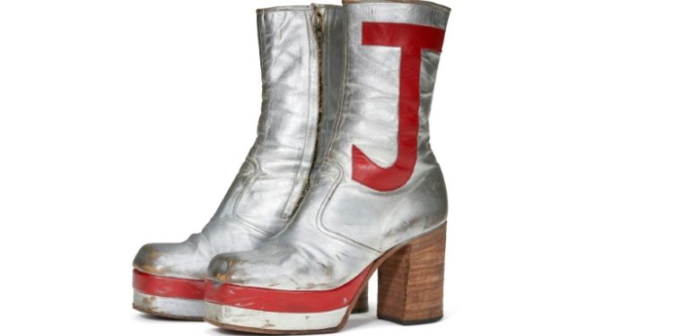 Elton John's monogrammed silver leather boots sold for nearly $100,000 at auction in New York. ©AFP