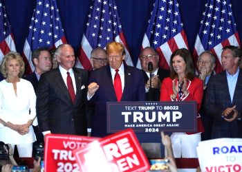 Former US president Donald Trump is flanked by supporters as he celebrates victory in South Carolina -- but there were signs of weakness for his presidential bid in the voting statistics / ©AFP