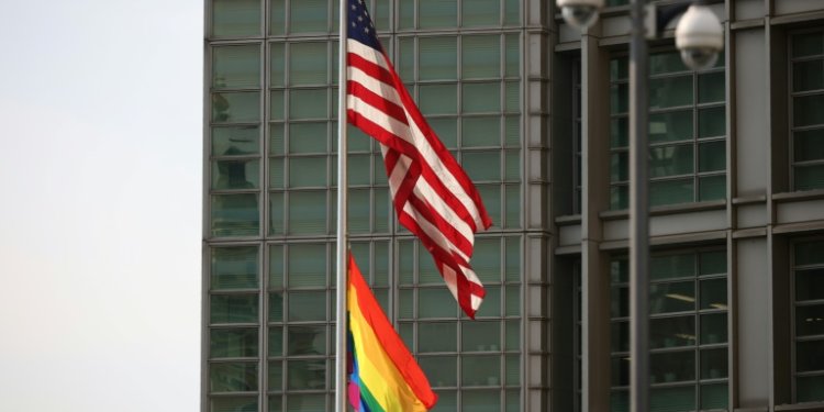 The rainbow Pride flag is seen hanging below the US flag outside the US embassy in Moscow on June 25, 2021, during Pride month. ©AFP