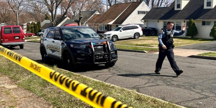 A police officer patrols a neighborhood in Levittown, Pennsylvania, just north of Philadelphia, following two shootings that left a total of three people dead . ©AFP