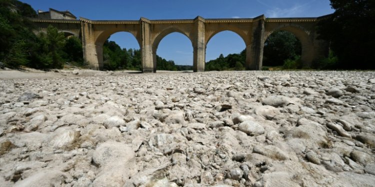 (FILES) A photograph shows the parched river bed of the Gardon near the Saint-Nicolas de Campagnac bridge in Saint-Anastasie, southern France, after a heat wave hit in June 2022. ©AFP