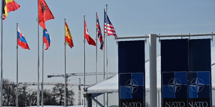 An empty mast is seen among member-nations at the NATO headquarters, ahead of a flag-raising ceremony for new member Sweden / ©AFP