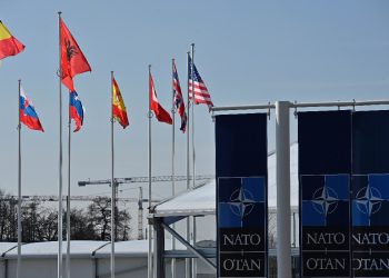 An empty mast is seen among member-nations at the NATO headquarters, ahead of a flag-raising ceremony for new member Sweden / ©AFP