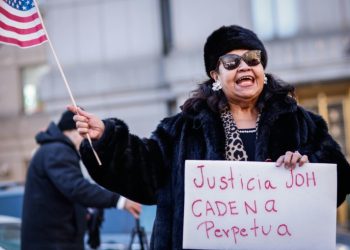 A protester demands life in prison for former Honduran president Juan Orlando Hernandez outside court in February . ©AFP