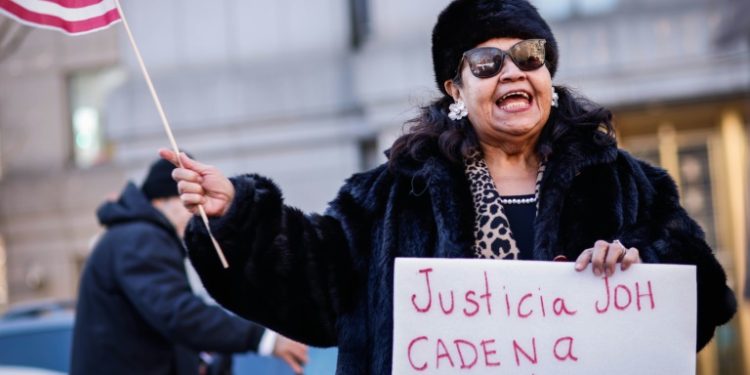 A protester demands life in prison for former Honduran president Juan Orlando Hernandez outside court in February . ©AFP