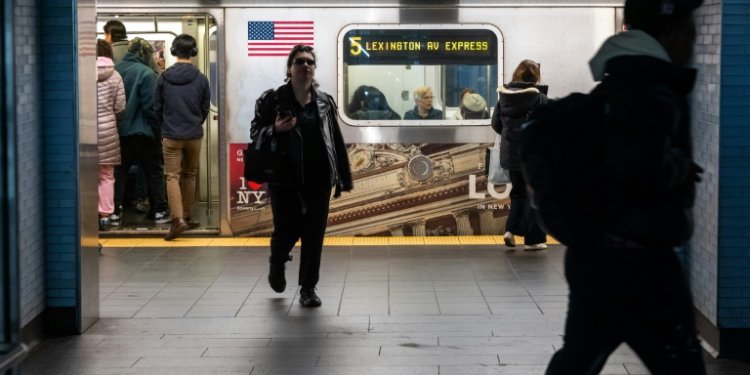 People exit and enter a subway car at a Manhattan subway station in March . ©AFP