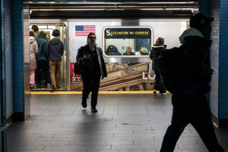 People exit and enter a subway car at a Manhattan subway station in March . ©AFP