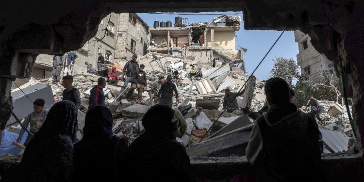 Palestinians check the rubble of buildings that were destroyed following overnight Israeli bombardment in Rafah, in the southern Gaza Strip / ©AFP