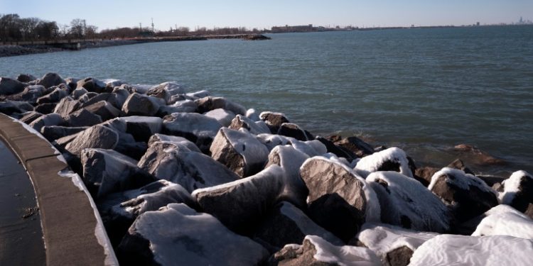 Ice collects on boulders along the Lake Michigan shoreline on February 18, 2024 in Whiting, Indiana; the Great Lakes shorelines have historically been ice-covered this time of year, but this winter's warm weather has led to historically low ice cover. ©AFP