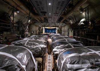 Humanitarian aid pallets rigged with parachutes for an airdrop over Gaza are loaded and prepared for takeoff onboard a US military cargo plane / ©AFP