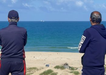 Palestinian men watch the Open Arms charity vessel bringing the first shipment of food aid to Gaza via a new maritime corridor from Cyprus. ©AFP