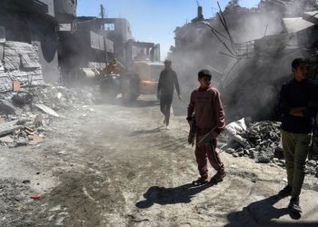 Palestinians clear a road of rubble after a night of Israeli bombing at Nuseirat refugee camp in the central Gaza Strip on Wednesday. ©AFP