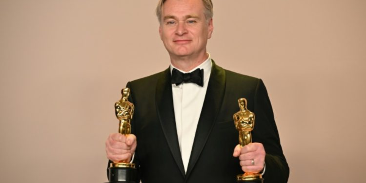 Christopher Nolan is finally an Oscar winner -- he posed with his awards for best director and best picture for 'Oppenheimer'. ©AFP