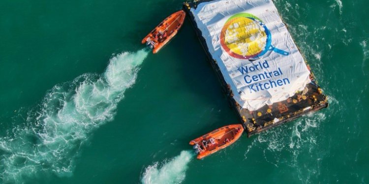 This picture released by the Israeli army shows a barge laden with food for Gaza being pushed towards a makeshift jetty for unloading after it was towed from Cyprus in a trial run for a new maritime aid corridor. ©AFP