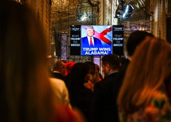 Supporters of former US President and 2024 presidential hopeful Donald Trump watch a screen announcing Trump wins Alabama as they attend a Super Tuesday election night watch party at Mar-a-Lago Club in Palm Beach, Florida, on March 5, 2024 / ©AFP