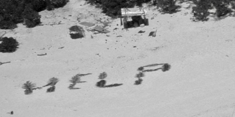 The 'HELP' sign made with palm fronds by three mariners stranded on a remote island in Micronesia is seen in an image obtained from the US Coast Guard. ©AFP