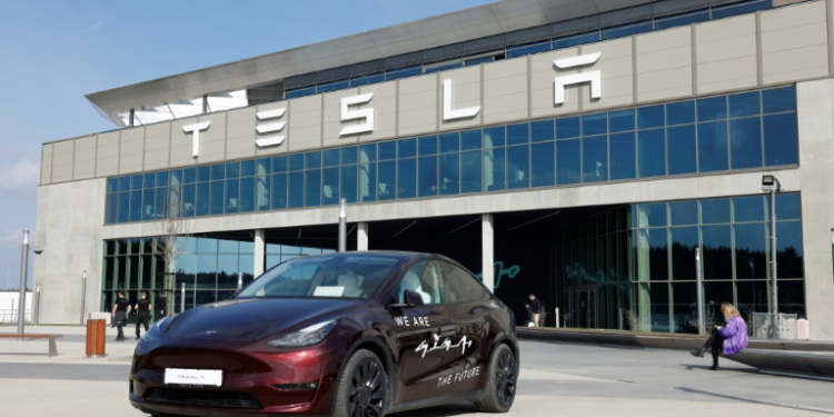 A Tesla car stands in front of the company's electric car plant in Gruenheide near Berlin, Germany, on March 13, 2024. ©AFP