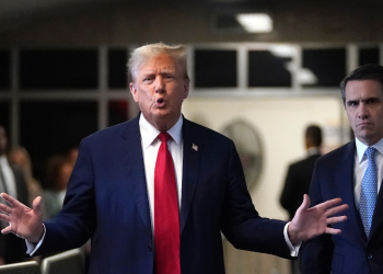 Former US President Donald Trump, with lawyer Todd Blanche (R), speaks to the press as he arrives at his trial for allegedly covering up hush money payments linked to extramarital affairs on April 23, 2024 / ©AFP