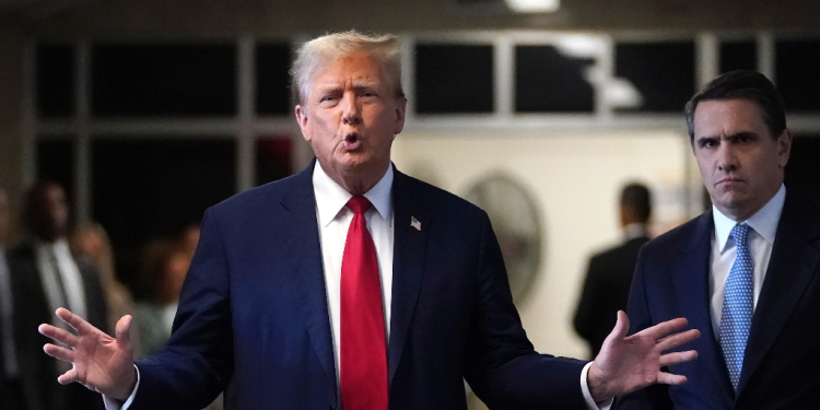 Former US President Donald Trump, with lawyer Todd Blanche (R), speaks to the press as he arrives at his trial for allegedly covering up hush money payments linked to extramarital affairs on April 23, 2024 / ©AFP