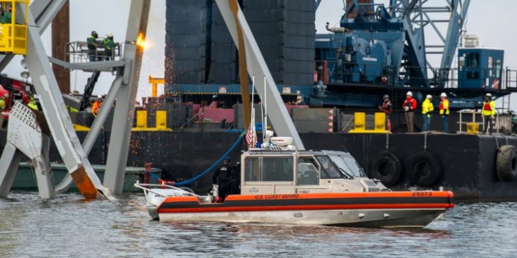 US authorities hope to create a temporary channel while they remove the wreckage of Baltimore's Francis Scott Key Bridge, seen here in this handout photo from the Coast Guard . ©AFP