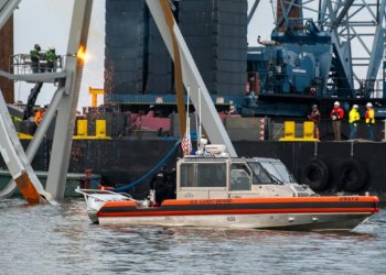 US authorities hope to create a temporary channel while they remove the wreckage of Baltimore's Francis Scott Key Bridge, seen here in this handout photo from the Coast Guard . ©AFP