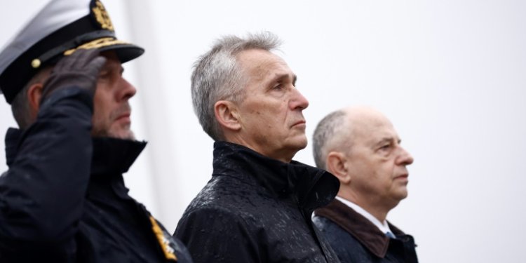 NATO Secretary General Jens Stoltenberg (C), flanked by the Chair of NATO's Military Committee Admiral Rob Bauer (L), and NATO Deputy Secretary General Mircea Geoana (R) attend a wreath laying ceremony for the alliance's 75th anniversary in Brussels. ©AFP