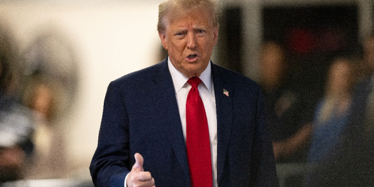 Former US President Donald Trump speaks to the media as he arrives for his trial for allegedly covering up hush money payments linked to extramarital affairs / ©AFP