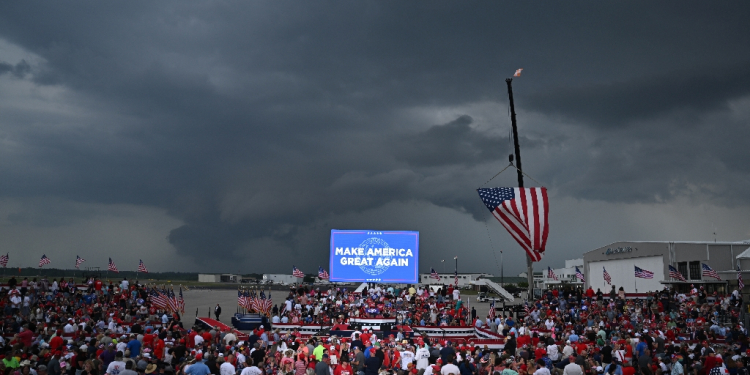 Supporters of Republican presidential candidate Donald Trump await his speech under the threat of a storm at a campaign rally in Wilmington, North Carolina, on April 20, 2024. The event was eventually called off because of weather / ©AFP