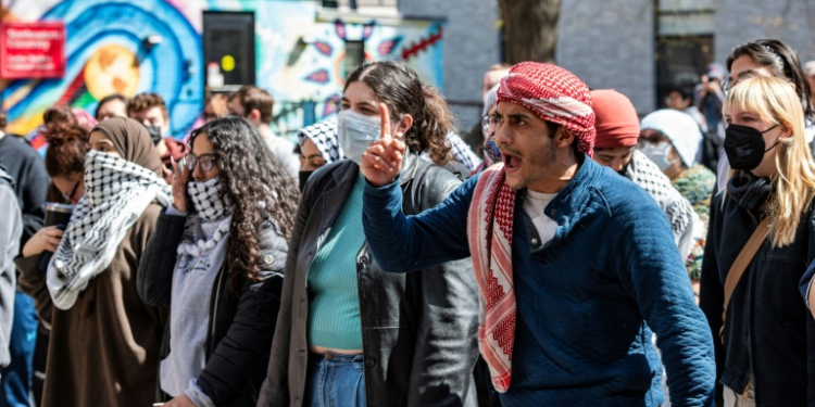 Pro-Palestinian protesters stand in front of a police barricade at Northeastern University in Boston, Massachusetts, on April 27, 2024. ©AFP