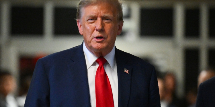 Former US president Donald Trump speaks to reporters after the opening day of his 'hush money' trial in New York / ©AFP