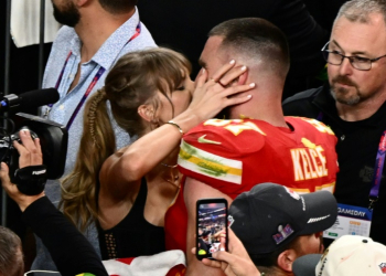 Taylor Swift, shown here kissing Travis Kelce at the 2024 Super Bowl, was spotted at Coachella similarly canoodling with her NFL boyfriend during the set of Bleachers, which is fronted by her producer. ©AFP