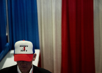 A man at a Republican event in Maryland on February 22, 2024, wears a cap to show support for people sentenced to jail for their roles in the January 6, 2021, occupation of the US Capitol  / ©AFP