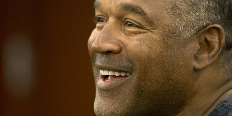 O.J. Simpson, shown here at a court hearing in 2013, went from the heights of fame as a successful football star and actor -- to the depths of infamy as a suspect in his ex-wife's murder and a conviction over a bungled armed robbery. ©AFP