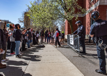 Pro-Palestinian protesters stand in front of a police barricade after police raided an encampment at Northeastern University in Boston, Massachusetts, on April 27, 2024 / ©AFP