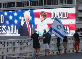 Then-US president Donald Trump and his wife Melania Trump are seen on a jumbo screen in Tel Aviv, Israel -- but lately, his level of support for Israel has been vague / ©AFP