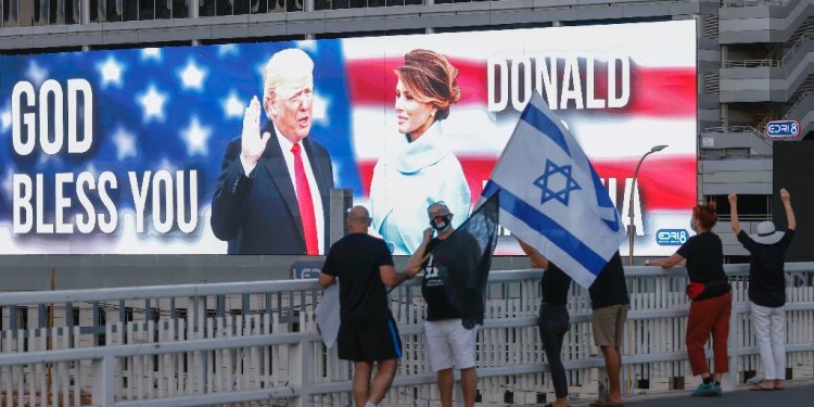 Then-US president Donald Trump and his wife Melania Trump are seen on a jumbo screen in Tel Aviv, Israel -- but lately, his level of support for Israel has been vague / ©AFP