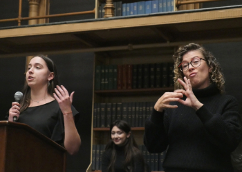 An interpreter signs in American Sign Language during a debate between Gallaudet University's debate team and Georgetown University's debate club, at the Riggs Library in Washington, on April 11, 2024 / ©AFP