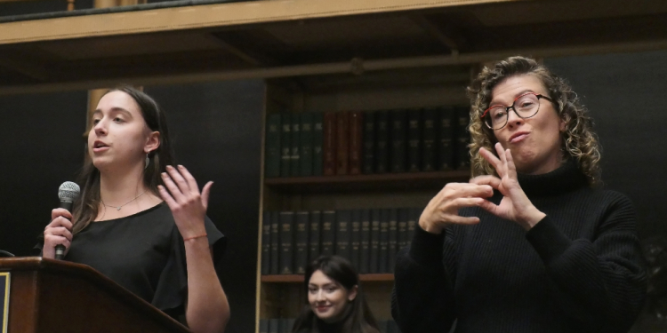 An interpreter signs in American Sign Language during a debate between Gallaudet University's debate team and Georgetown University's debate club, at the Riggs Library in Washington, on April 11, 2024 / ©AFP