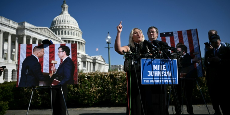 US Republican Representatives Marjorie Taylor Greene (C), holds a press conference on House Democratic Leader Hakeem Jeffries' (L in photo) endorsement of Republican House Speaker Mike Johnson (R in photo), outside the US Capitol in Washington, DC, on May 1, 2024. ©AFP