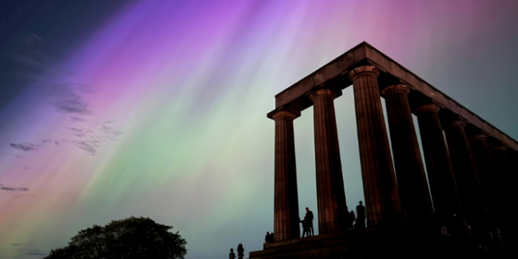 This handout photo taken and released by Jacob Anderson shows the northern lights, or aurora borealis, during a solar storm over the National Monument of Scotland in Edinburgh. ©AFP