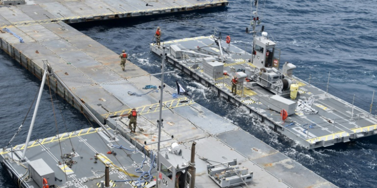 A handout photo courtesy of the US Central Command (CENTCOM) taken on April 26, 2024, shows construction work on the floating JLOTS pier in the Mediterranean Sea. ©AFP