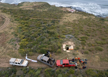 Rescue workers, forensics investigators and prosecutors preparing to enter a shaft where human remains were found near La Bocana Beach in Ensenada, Baja California state on May 3, 2024. ©AFP