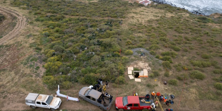 Rescue workers, forensics investigators and prosecutors preparing to enter a shaft where human remains were found near La Bocana Beach in Ensenada, Baja California state on May 3, 2024. ©AFP