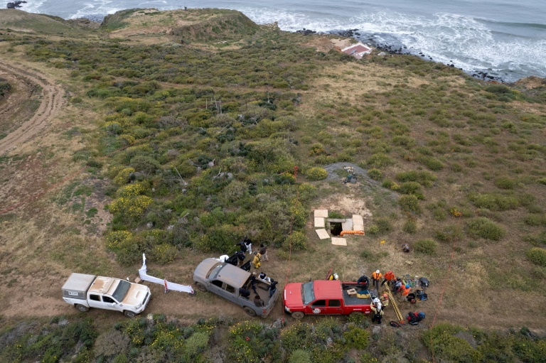 Rescue workers, forensics investigators and prosecutors preparing to enter a shaft where human remains were found near La Bocana Beach in Ensenada, Baja California state on May 3, 2024. ©AFP