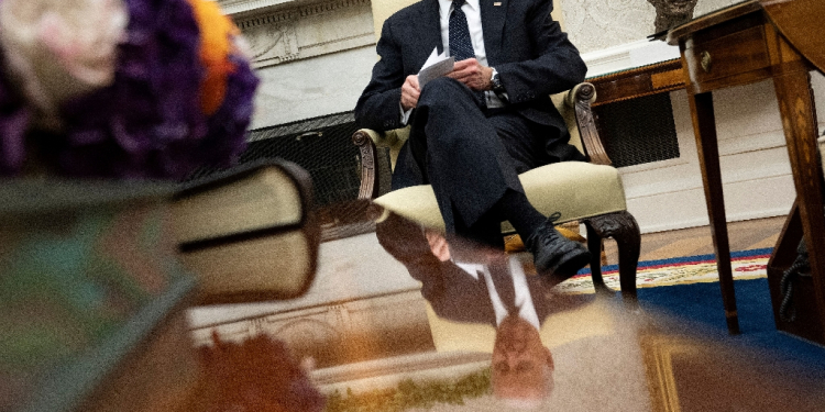 US President Joe Biden looks at note cards as he meets with Romanian President Klaus Iohannis in the Oval Office of the White House in Washington, DC, on May 7, 2024. / ©AFP