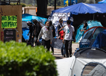 People walk inside a pro-Palestinian protest encampment on the campus of the University of California, Los Angeles (UCLA) in Los Angeles, California, on May 1, 2024 / ©AFP