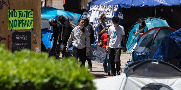 People walk inside a pro-Palestinian protest encampment on the campus of the University of California, Los Angeles (UCLA) in Los Angeles, California, on May 1, 2024 / ©AFP