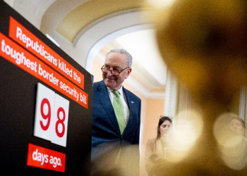 Senate Majority Leader Chuck Schumer stands next to a poster that reads Republicans killed the toughest border security bill 98 days ago. Democrats are ready to act  / ©AFP