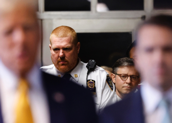 US Speaker of the House Mike Johnson (second R) listens as former president Donald Trump (L) speaks to reporters beforing entering his trial over allegedly covering up hush money payments  / ©AFP